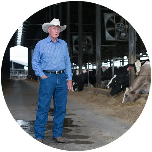 Larson Family Larson Family Member Standing at dairy farm.